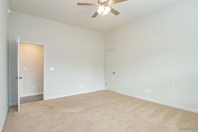 spare room featuring ceiling fan, carpet floors, and baseboards