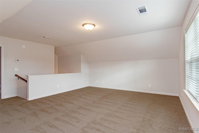 bonus room with vaulted ceiling, carpet flooring, visible vents, and baseboards