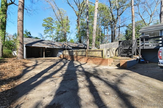 view of yard featuring fence and stairs