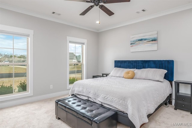 bedroom featuring light colored carpet, visible vents, crown molding, and multiple windows