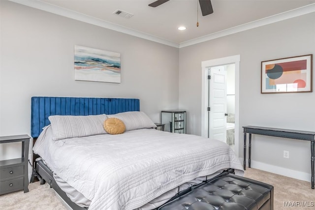 bedroom featuring light carpet, baseboards, visible vents, ensuite bath, and crown molding