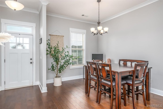 dining space with baseboards, visible vents, dark wood-type flooring, and ornamental molding