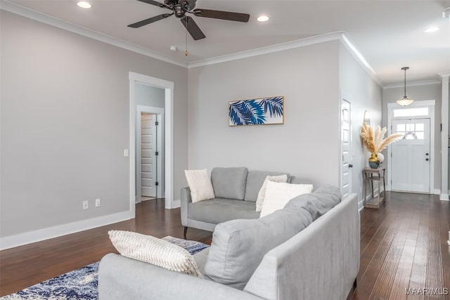 living room with ornamental molding, dark wood-type flooring, recessed lighting, and baseboards