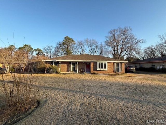 single story home featuring brick siding