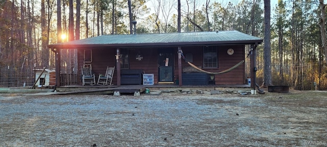 rustic home with covered porch and metal roof