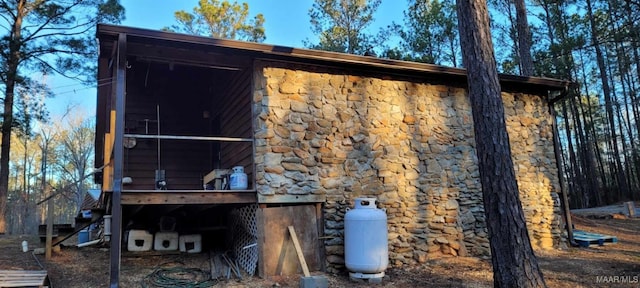 back of house with stone siding