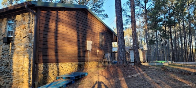 view of side of home featuring stone siding