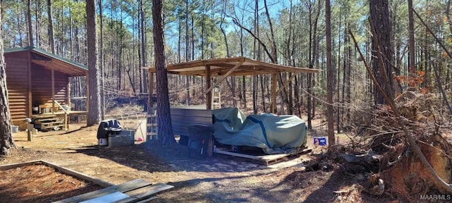 view of yard with a view of trees