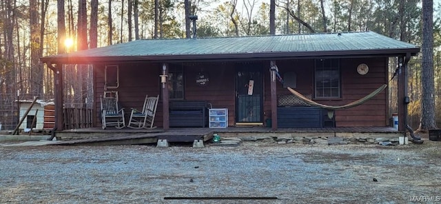 chalet / cabin with a porch and metal roof