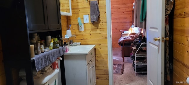 bathroom with wood walls and vanity