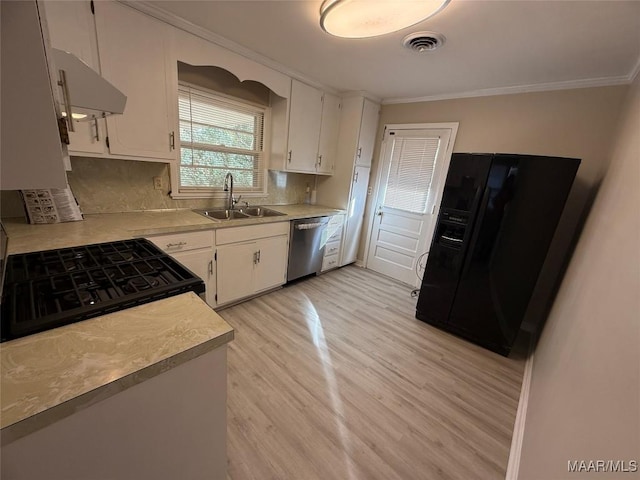 kitchen with light countertops, black fridge with ice dispenser, stainless steel dishwasher, and white cabinetry