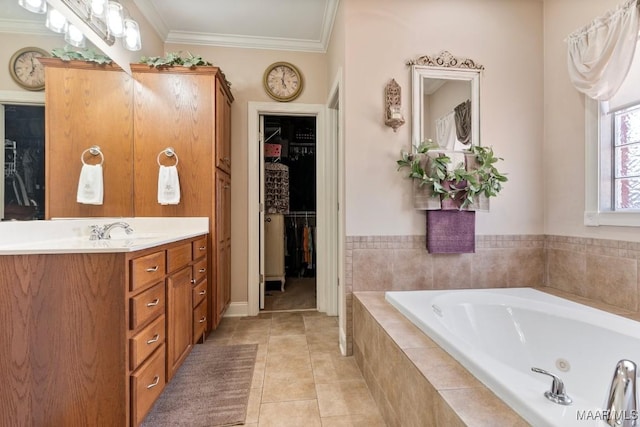 bathroom featuring ornamental molding, a garden tub, tile patterned flooring, a spacious closet, and vanity