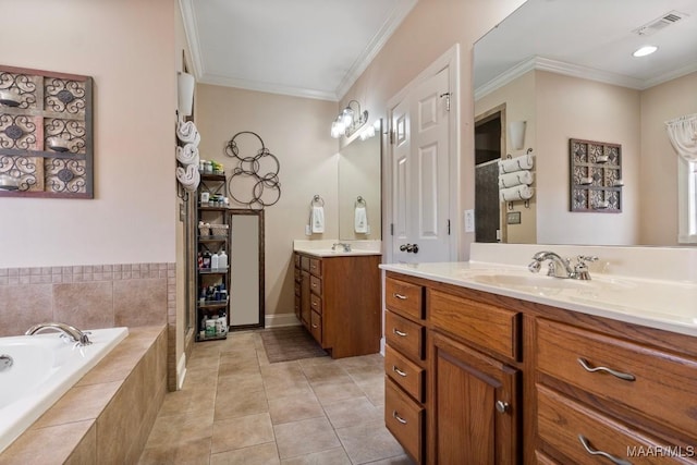 bathroom featuring tile patterned flooring, two vanities, a sink, ornamental molding, and a bath