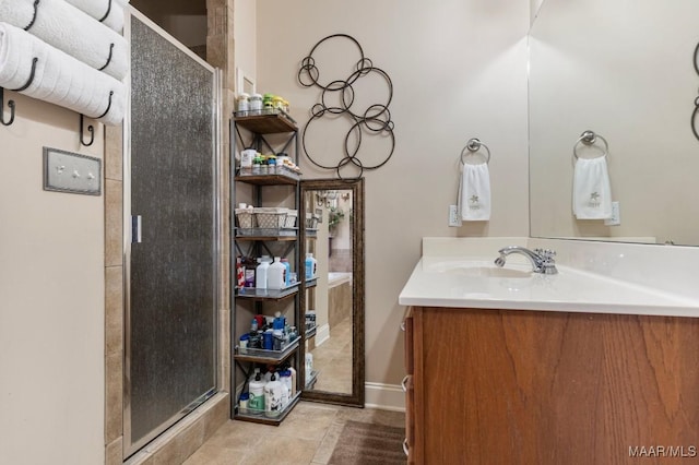 bathroom with a shower stall and vanity