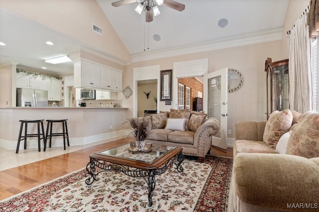 living area with light wood-style floors, ceiling fan, visible vents, and crown molding