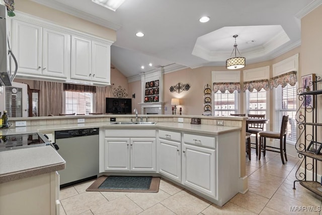 kitchen featuring a peninsula, white cabinetry, light countertops, and stainless steel dishwasher