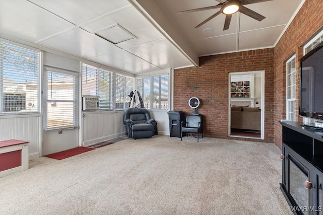 sunroom / solarium featuring plenty of natural light and ceiling fan