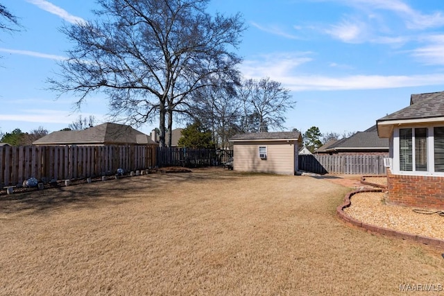 view of yard with an outbuilding, a shed, and a fenced backyard