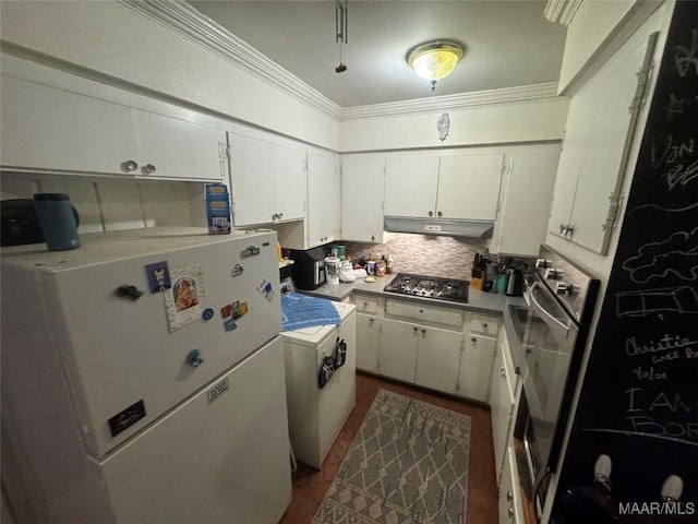 kitchen featuring under cabinet range hood, stainless steel gas stovetop, white cabinets, and freestanding refrigerator