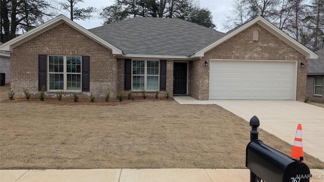 ranch-style house with a garage, brick siding, concrete driveway, roof with shingles, and a front yard