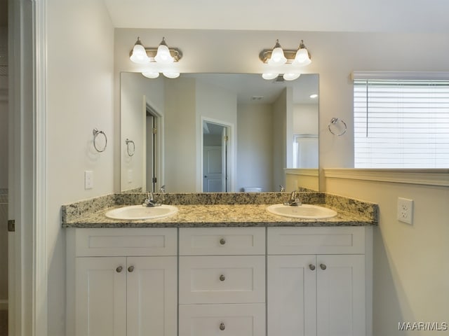 full bathroom featuring double vanity and a sink