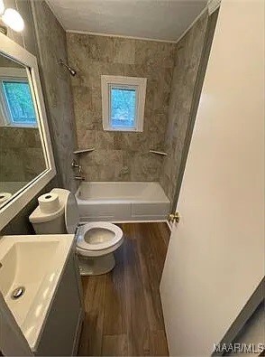 4325 Zorn Ln, Montgomery, AL 36116 - bathroom featuring shower / bath combination, a healthy amount of sunlight, vanity, and toilet