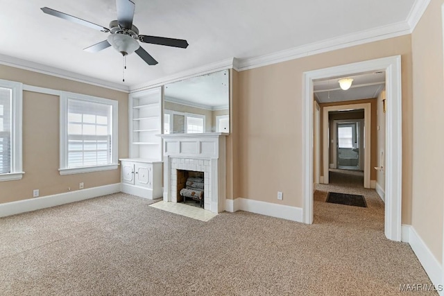 unfurnished living room with light carpet, baseboards, ornamental molding, and a tile fireplace