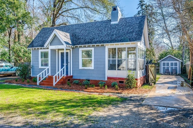 view of front facade featuring entry steps, a chimney, crawl space, an outdoor structure, and a shed