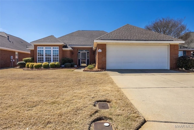 single story home with a garage, a front yard, concrete driveway, and a shingled roof