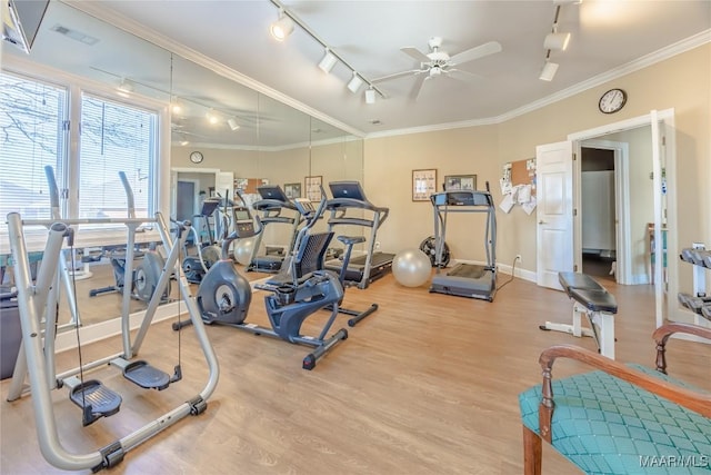 gym featuring light wood finished floors, visible vents, a ceiling fan, ornamental molding, and rail lighting