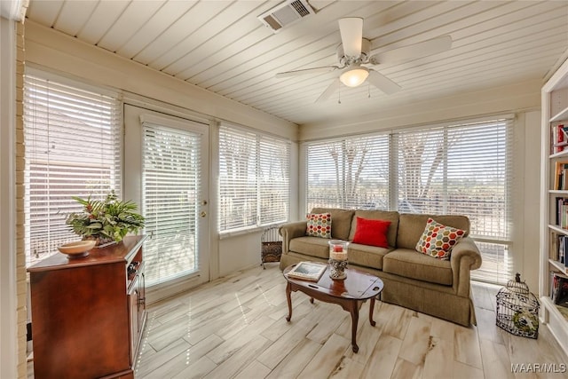 sunroom featuring ceiling fan, wood ceiling, visible vents, and a wealth of natural light