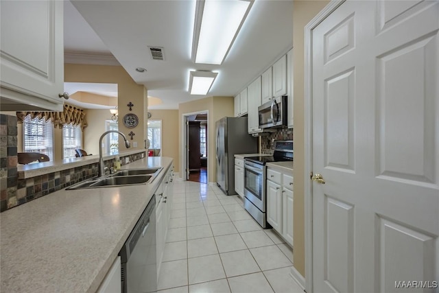 kitchen with visible vents, white cabinets, appliances with stainless steel finishes, light countertops, and a sink