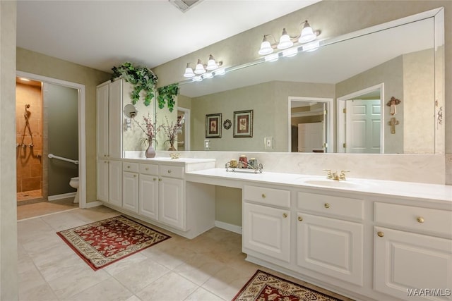 full bath with tile patterned flooring, a sink, toilet, and double vanity