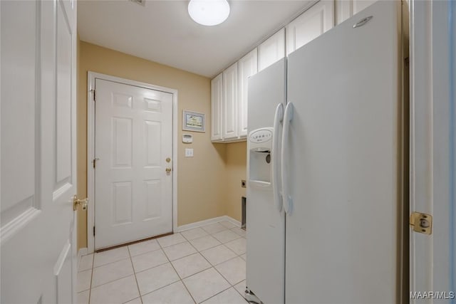 laundry room featuring baseboards and light tile patterned floors