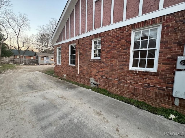 view of side of home featuring crawl space and brick siding