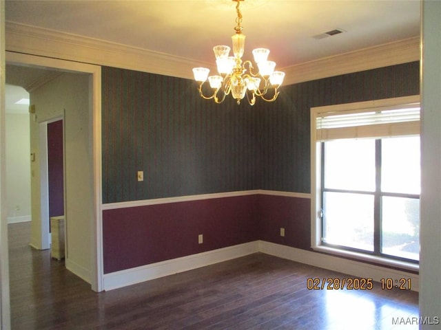 unfurnished room featuring wood finished floors, crown molding, baseboards, and wallpapered walls