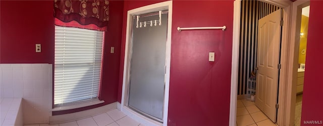 interior space with a shower with door, tile patterned flooring, and a washtub