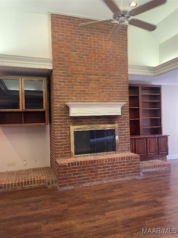 unfurnished living room with ceiling fan, a fireplace, high vaulted ceiling, and wood finished floors