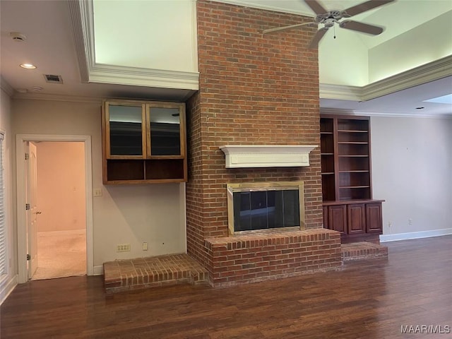 unfurnished living room with a fireplace, visible vents, ornamental molding, wood finished floors, and baseboards