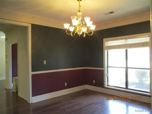 unfurnished room featuring crown molding, wood finished floors, visible vents, baseboards, and wallpapered walls