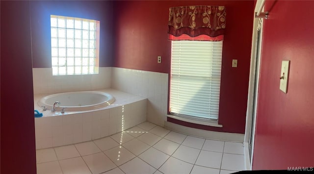 bathroom with a bath and tile patterned floors