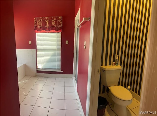 full bath with a stall shower, toilet, and tile patterned floors