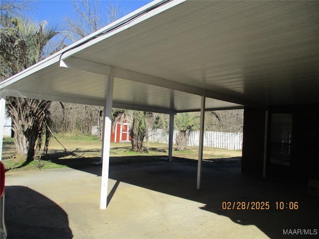 view of patio / terrace with a carport and fence