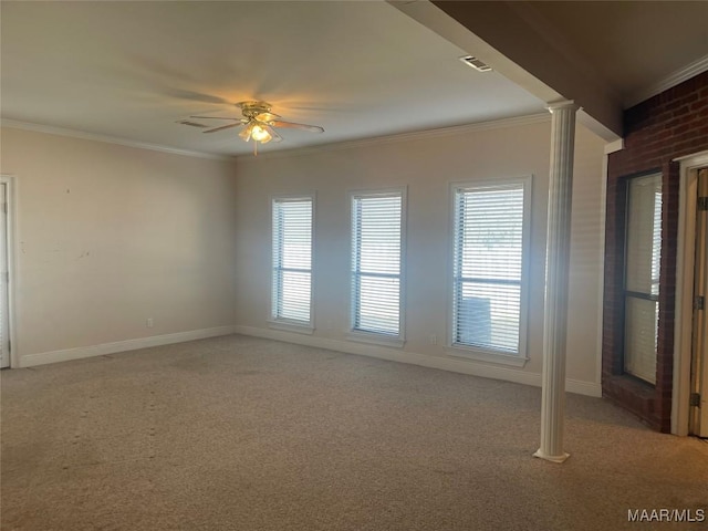 spare room featuring ornamental molding, light colored carpet, visible vents, and a ceiling fan