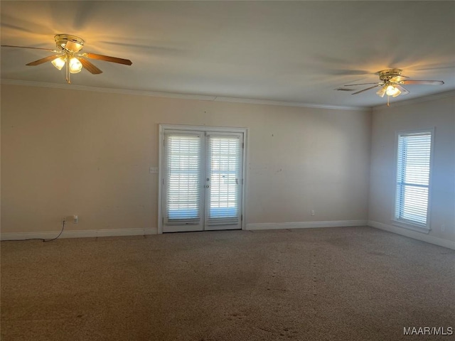 spare room featuring light carpet, plenty of natural light, and ornamental molding