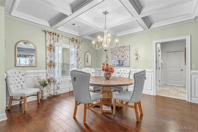 dining space with visible vents, dark wood finished floors, beam ceiling, and a notable chandelier