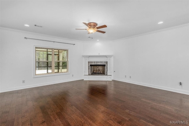 unfurnished living room featuring a fireplace, visible vents, baseboards, dark wood-style floors, and crown molding