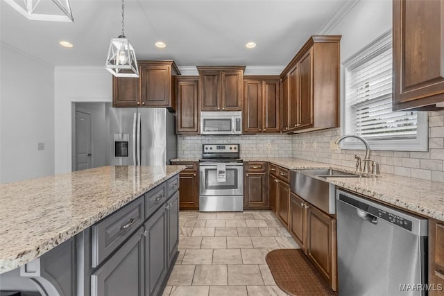 kitchen with decorative backsplash, ornamental molding, hanging light fixtures, stainless steel appliances, and a sink