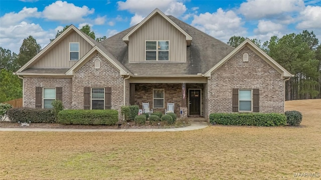 craftsman-style home featuring brick siding and a front yard