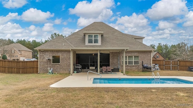 back of property featuring a patio, brick siding, a fenced backyard, and a fenced in pool